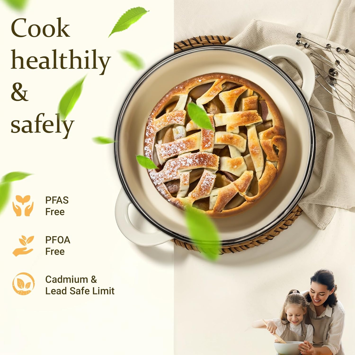 Cream white enameled cast iron Dutch oven with matching lid, displayed with included cookbook and cotton potholders — view 2