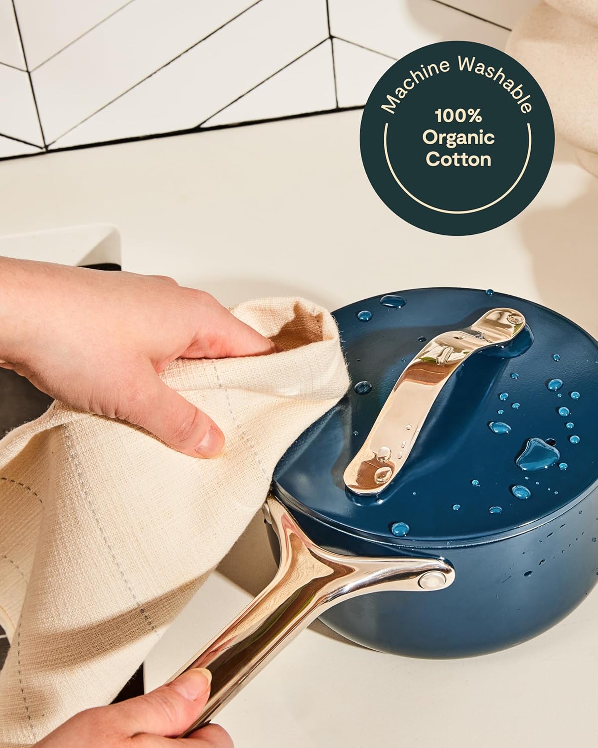 Four-piece organic cotton kitchen linen set including natural linen apron, matching pot holders, oven mitts, and tea towels — view 3