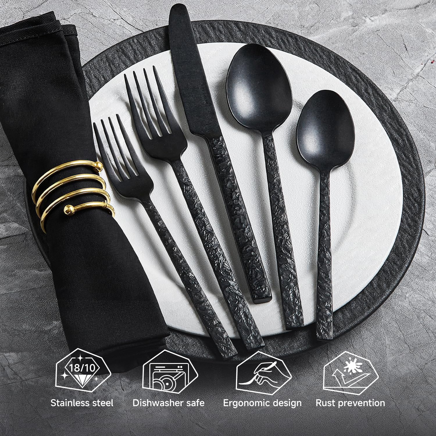 Black hammered stainless steel silverware set with fork, knife, and spoon pieces arranged on white background — view 3