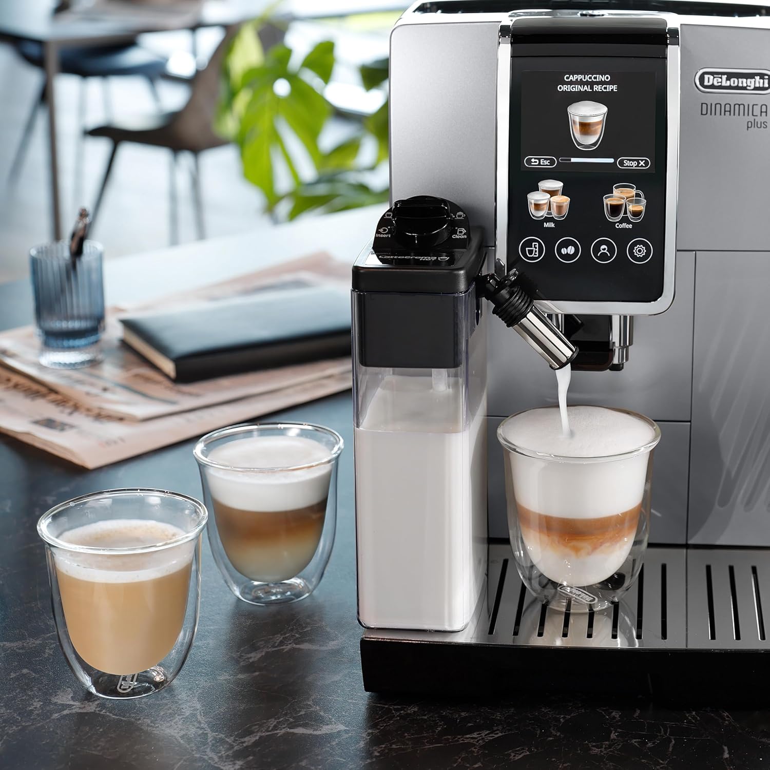 Stainless steel De'Longhi Dinamica Plus fully automatic espresso machine with integrated grinder and milk frother on countertop — side
