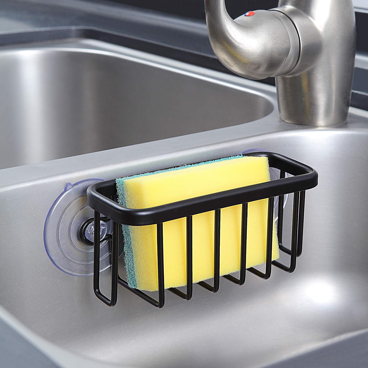 Black aluminum sink caddy with adhesive mount and suction cup, holding kitchen sponges and soap โ view 7b
