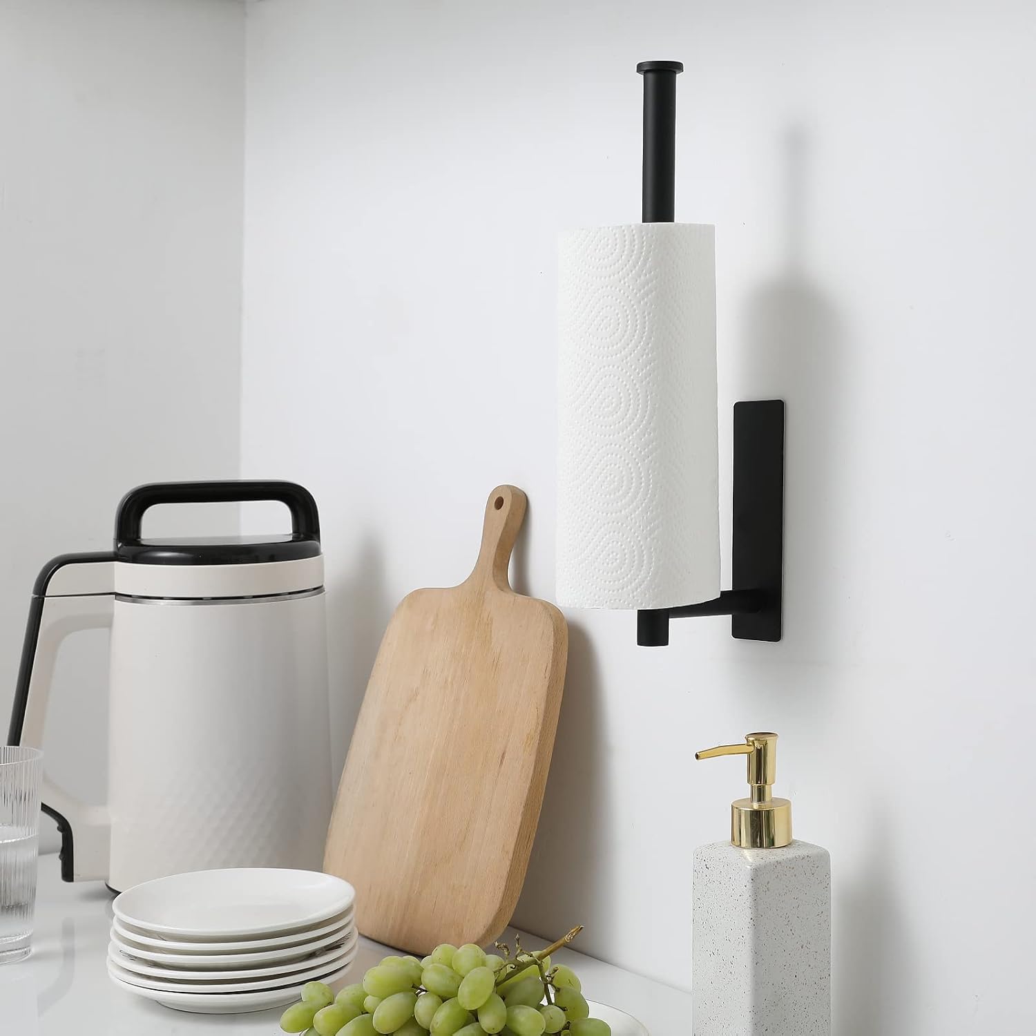 Black plastic adhesive under-cabinet paper towel holder mounted on kitchen cabinet — view 3