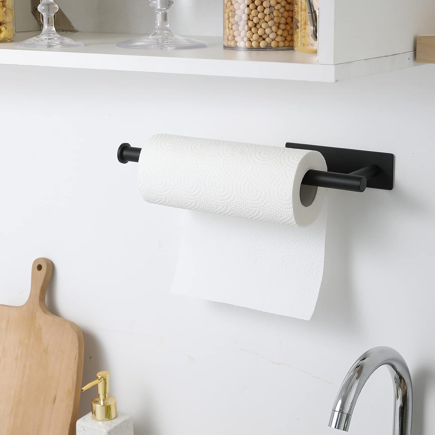 Black plastic adhesive under-cabinet paper towel holder mounted on kitchen cabinet — view 4