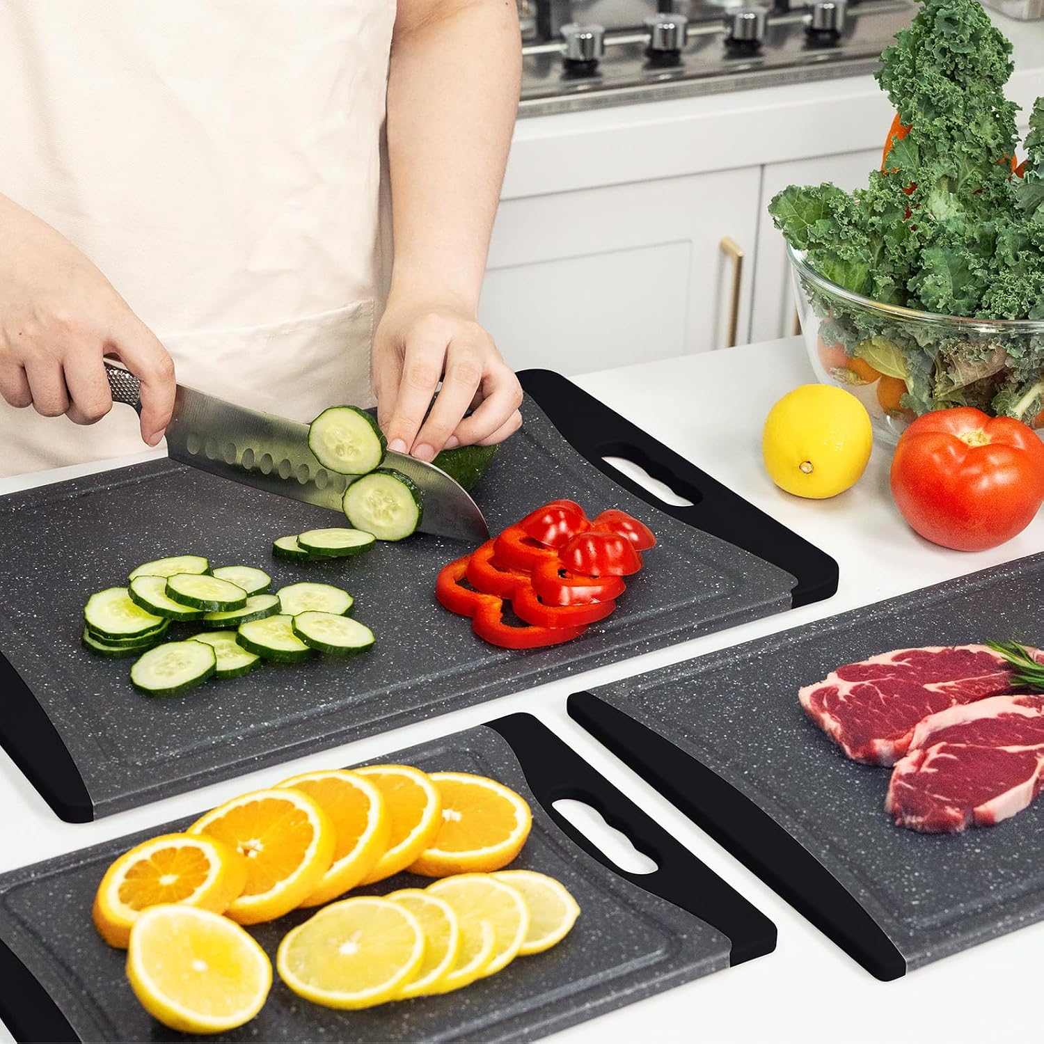 Dark grey plastic cutting board with juice grooves and easy-grip handles, part of 3-piece kitchen set — view 6
