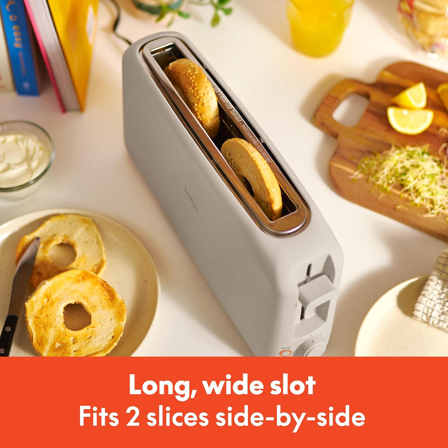 Oatmilk stainless steel 2-slice slim toaster with extra-wide slots on white countertop — detail